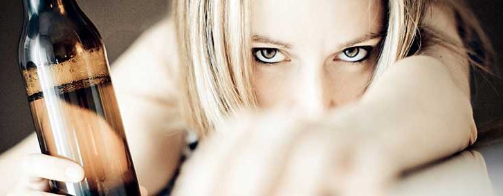 An image of a woman holding a beer bottle.