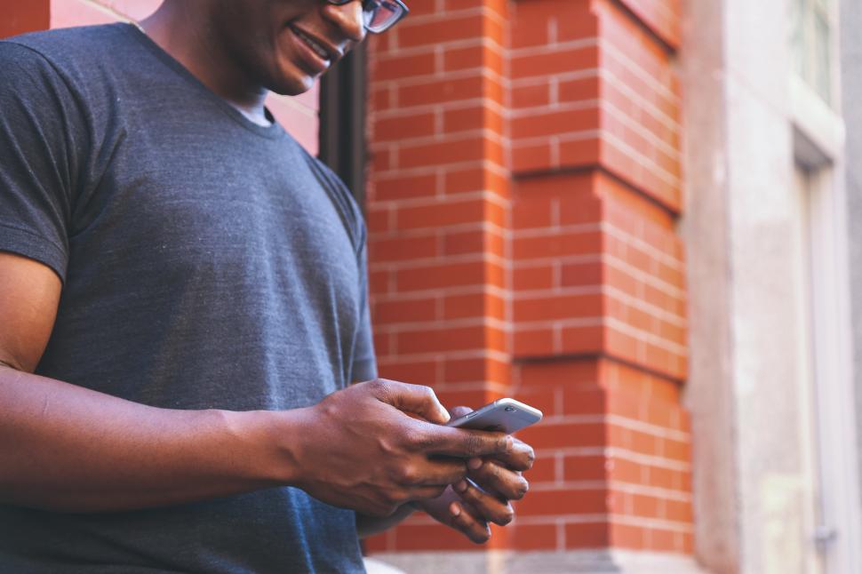 man texting & walking