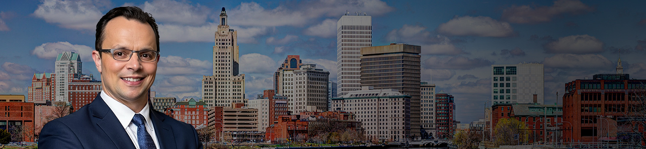 David Tapalian with the Providence Rhode Island Skyline with a dark filter in the background