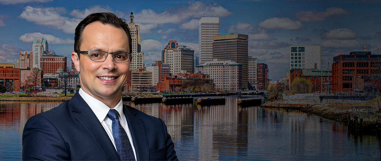 David Tapalian with the Providence Rhode Island Skyline with a dark filter in the background